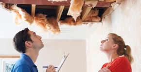 Builder And Client Inspecting Roof Damage